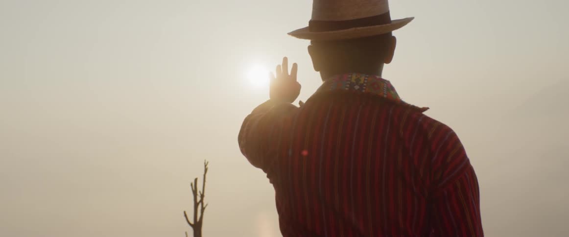 A man holds his hand up to the sun