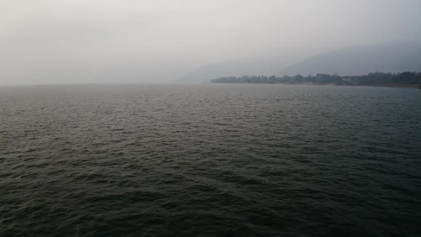 An aerial view of an ocean at haze