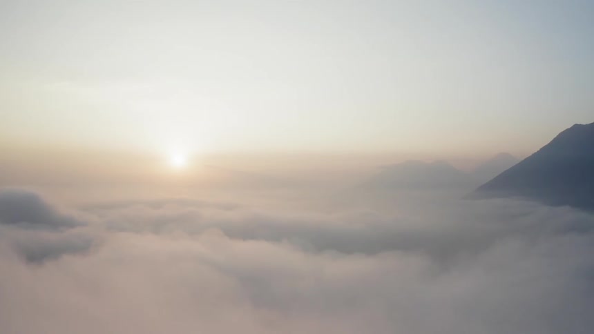 Clouds with mountains and the sun in the background