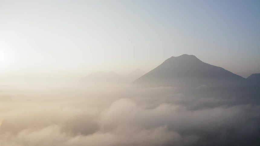Peak of a mountain over low lying clouds and fog
