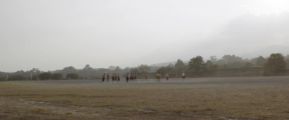 A group of people playing soccer on a field