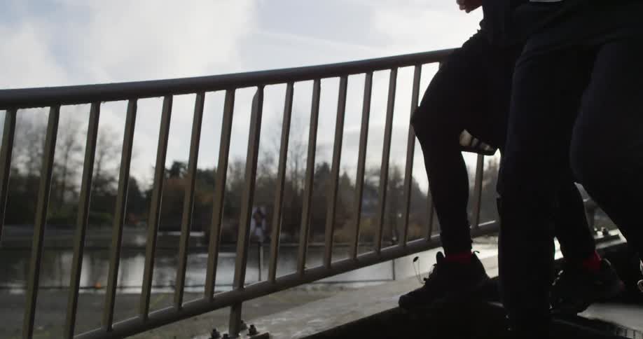 Two people rush down some outside stairs