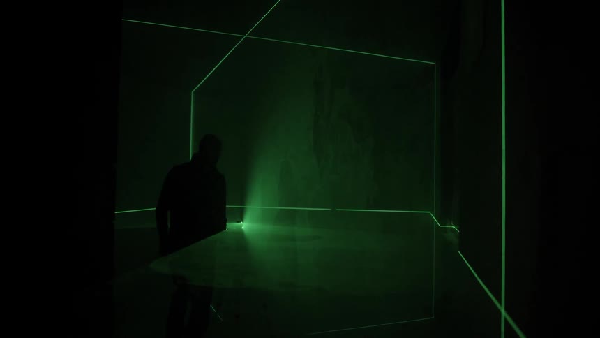 A man with light in the green neon room