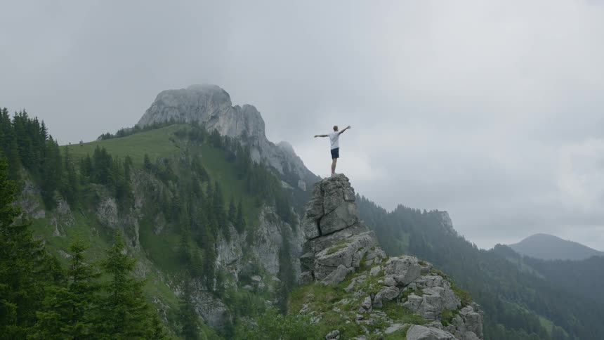 A man standing on top of a rock