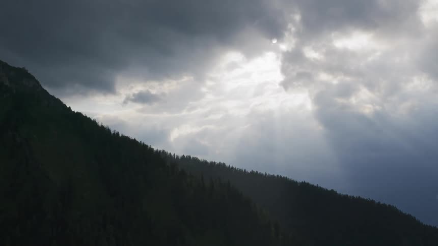 Clouds float above a hill