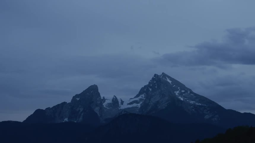 Clouds move over a mountain peak