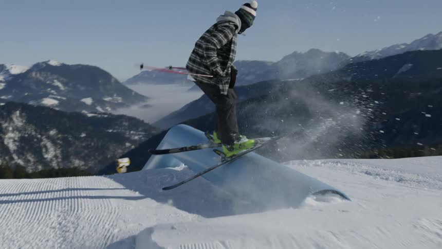 A skier pulling tricks on a downhill course