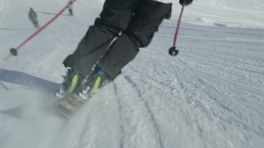 People ski down a snowy slope