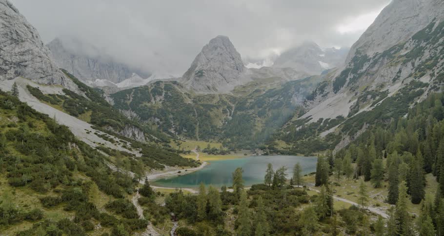 Lake on valley surrounded by mountains