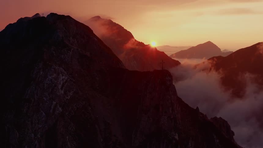 A silhouette of a mountain range at dawn