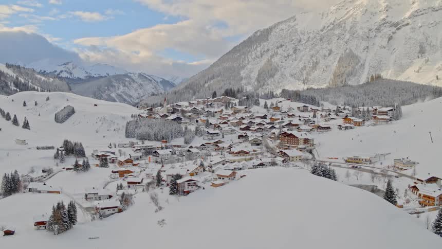 An aerial view of a village in the winter