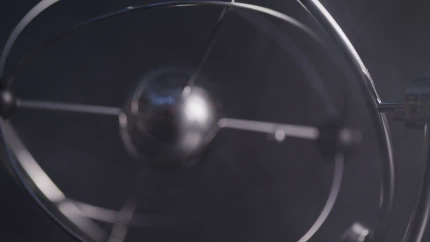 A metallic ball rotating in the dark