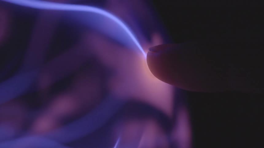 Finger touching a plasma ball creating a laser bolt