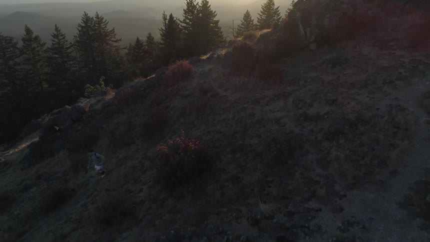 An aerial view of a man running downhill