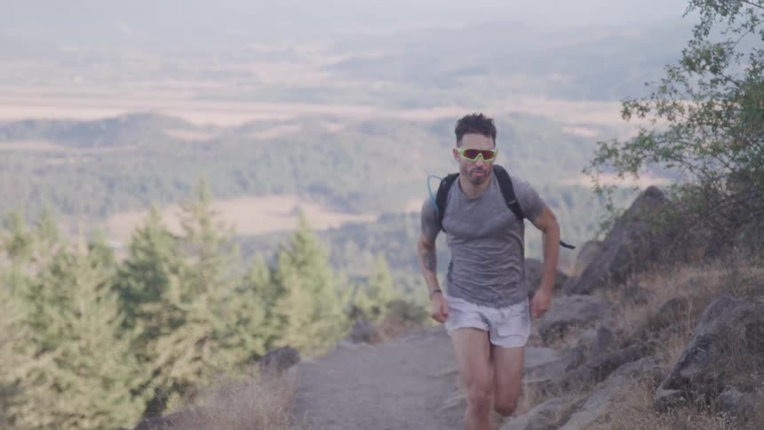 Man runs up hills on during daylight