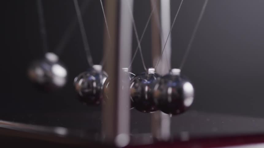 Pendulum balls swinging back and from their cradle