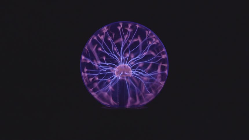 A glass ball filled with purple and pink electrical currents