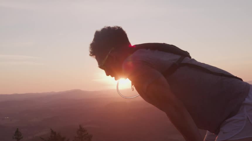 A man bends over breathing heavy from exhaustion