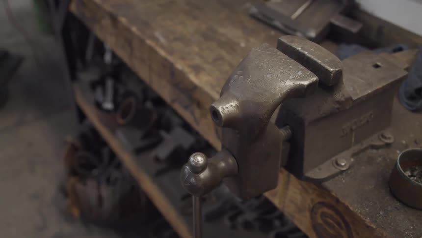 An iron machine at wooden desk