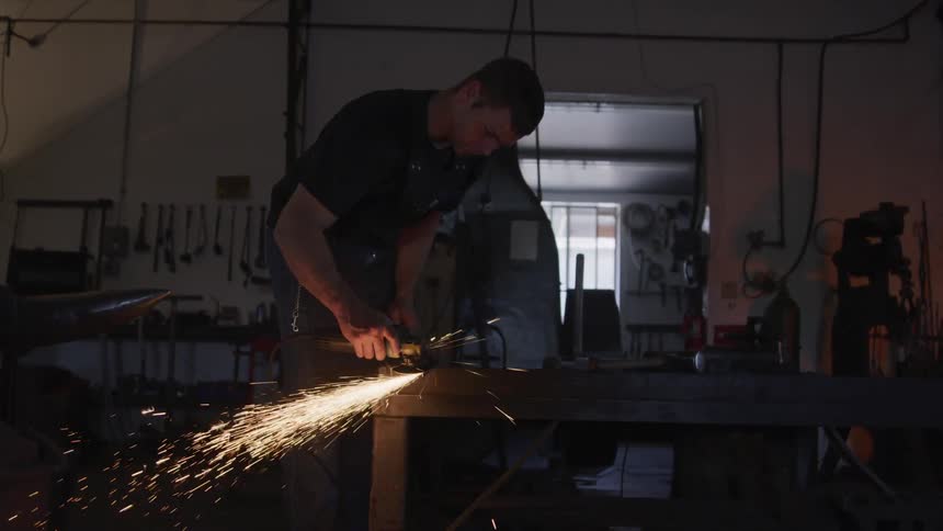 A man grinding something at the workshop