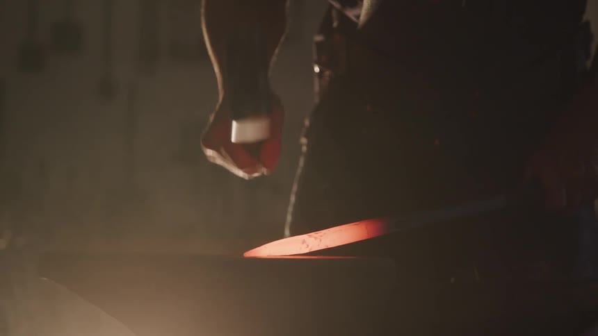 A man hitting heated metal