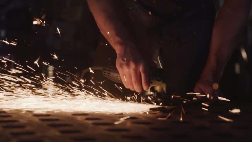 Man creates sparks while using a tool