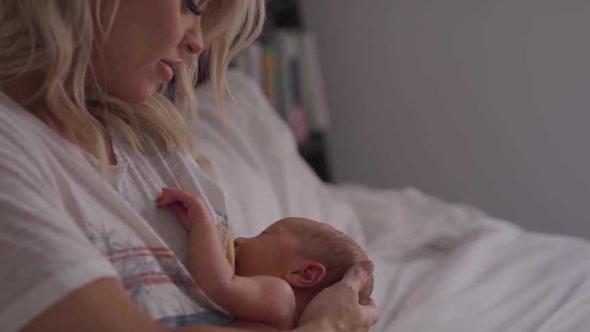 Close up shot of woman breastfeeding baby