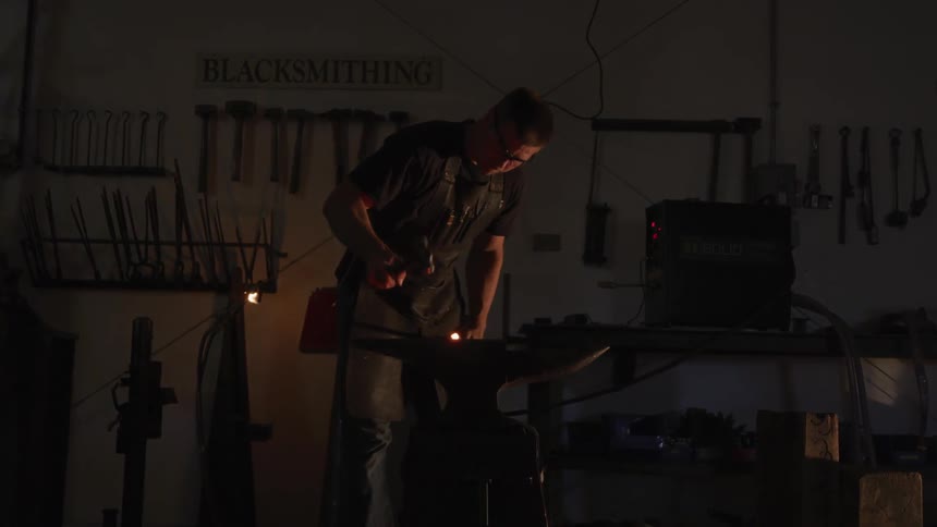 A man smithing in the dark