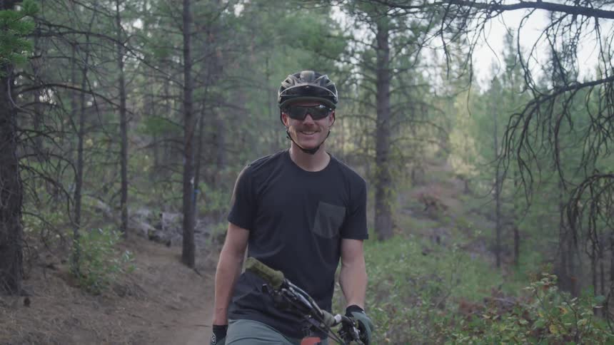 A man on a bike in the forest