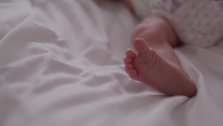 A newborn baby wriggles