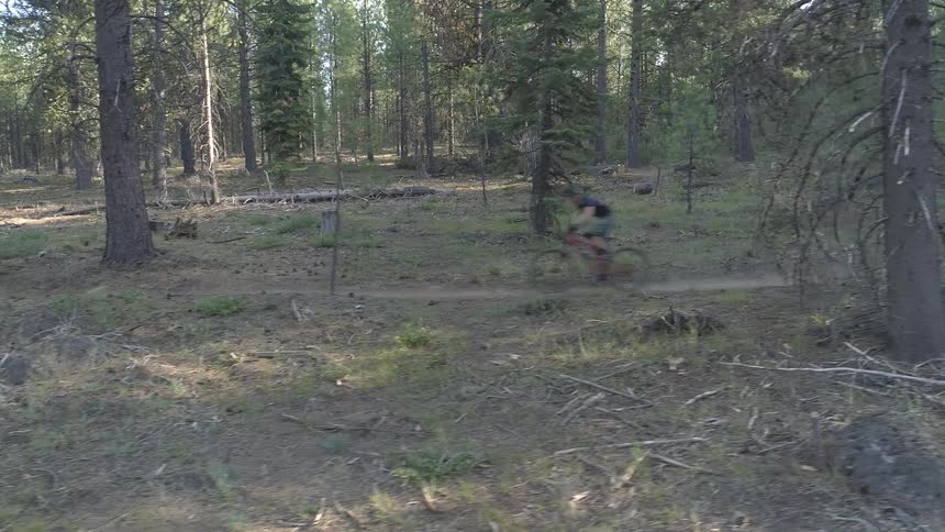 A shot of a biker biking down a path