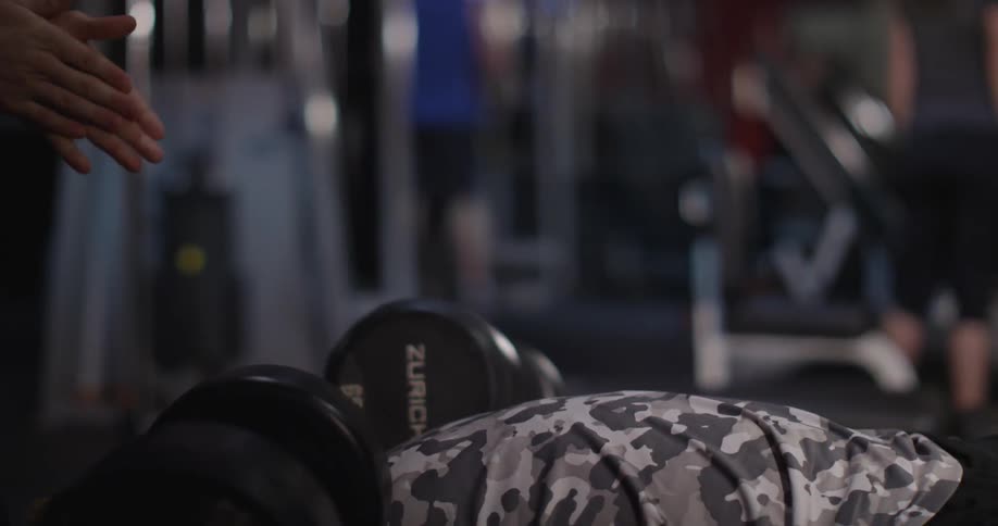 People are working out lifting weights in a gym