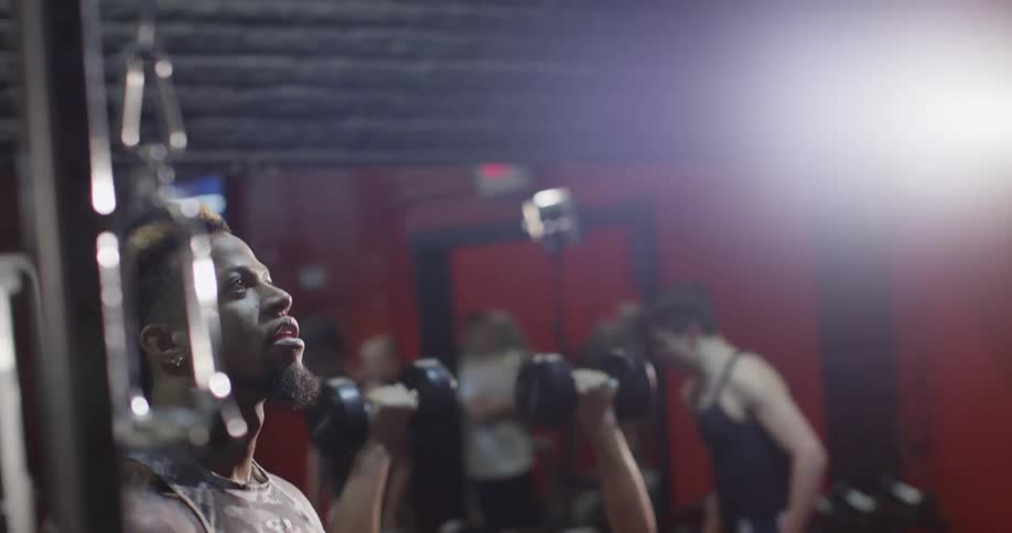 A man encourages another man at the gym