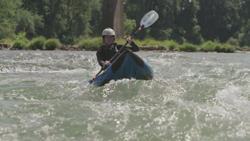 A man doing canoe at the harsh river