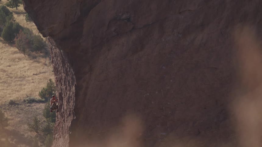 A scenery of a man climbing cliff