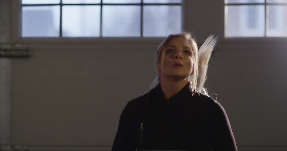 A woman is running in place inside of a building