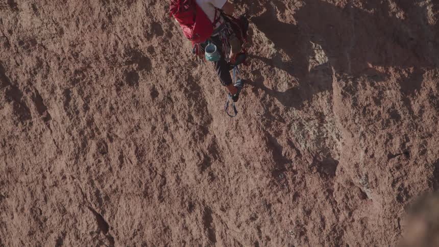 A man is climbing a mountain outdoors