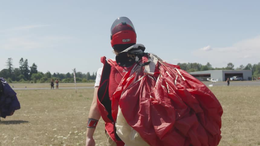 A man walking with a parachute