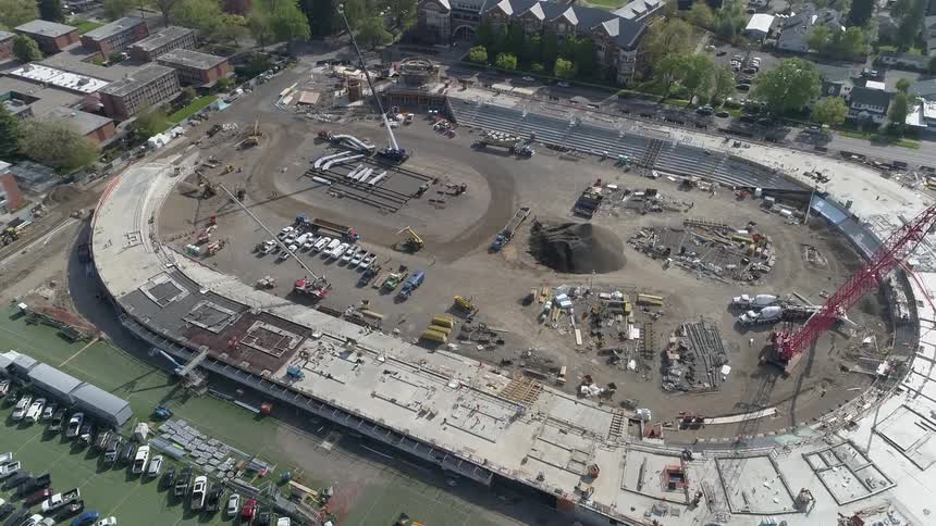 A construction site in the shape of a stadium during the day