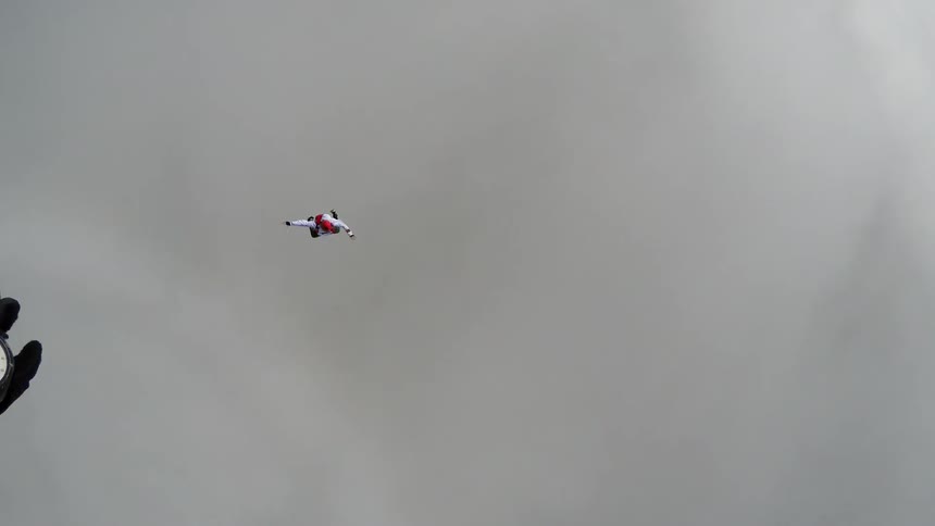 Skydivers jumping out of a small airplane