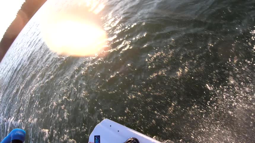Man practices water sky on lake at sunset