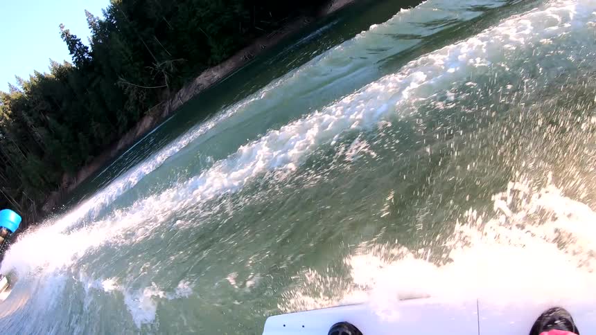 A person water skis behind a boat