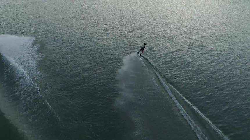 A man doing a surf boarding at the lake