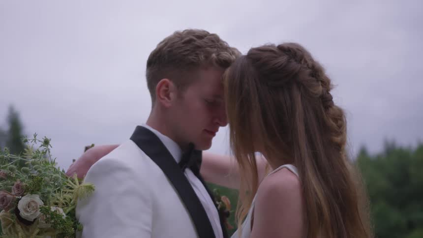 Groom and bride hold each other during the wedding ceremony