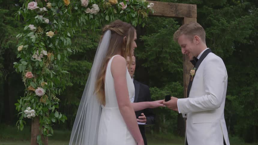 A man and woman are getting married outdoors