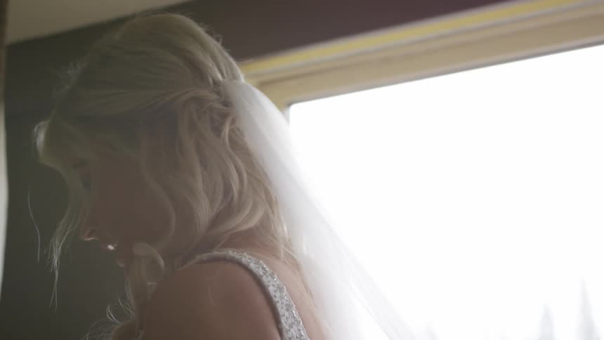 A person fixes a brides veil