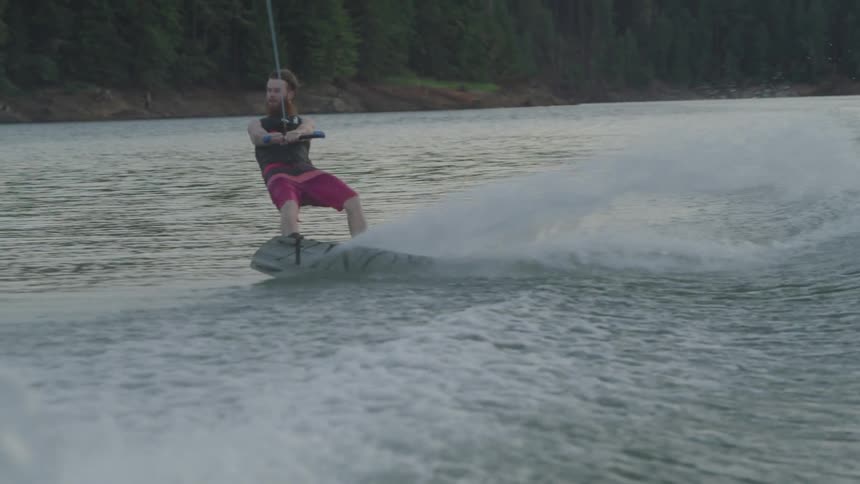 A person is surfing the water on a water ski