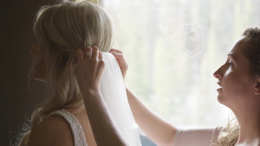 A woman helping her friend on the wedding preparation
