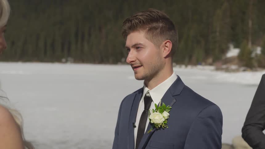 A young man stands outside saying his vows