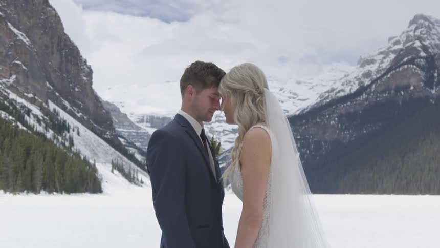Bride and groom kissing in the middle of mountain
